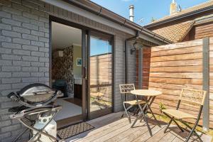 un patio con mesa y sillas en una terraza en Stagford Retreat Apartment - Taupo, en Taupo