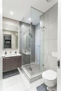 a bathroom with a shower and a toilet and a sink at Menlyn Maine - The Trilogy Apartment 1111 in Pretoria
