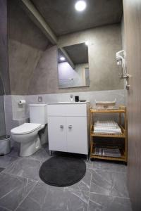a bathroom with a toilet and a sink and a mirror at THOMAS LUXURY APARTMENT in the historical center of Ioannina in Ioannina