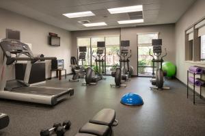 a gym with treadmills and machines in a room at Courtyard by Marriott Scottsdale Salt River in Scottsdale