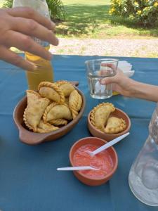 una mesa azul con dos tazones de comida y una bebida en Puesta del Sol en Salta