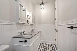 a white bathroom with a sink and a toilet at La Belle Veranda Villa- 3QueenBeds/2Baths Sleeps 6-8 in New Orleans