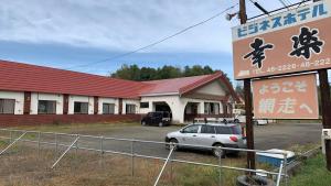 a car parked in a parking lot in front of a building at ビジネスホテル幸楽 in Abashiri