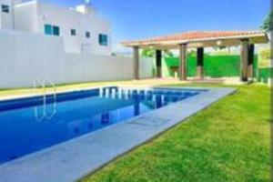 a swimming pool with a pavilion next to a building at "Escapada perfecta" casa con albeca, jacuzzi y roof garden in Tlatenchu