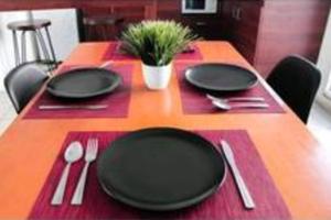 a table with black plates and utensils on it at "Escapada perfecta" casa con albeca, jacuzzi y roof garden in Tlatenchu +13 photos