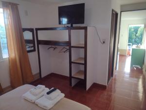 a bedroom with a bunk bed with towels and a television at Flor de Cardón in La Rioja