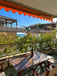 a table with a bottle of wine on a balcony at TERRAZZA vista MARE - SEA view Terrace in Sanremo