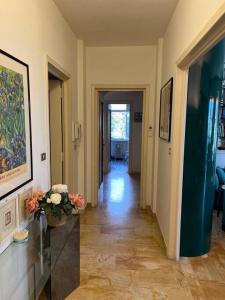 a hallway with a vase of flowers on a table at TERRAZZA vista MARE - SEA view Terrace in Sanremo