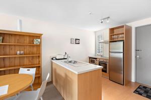 a kitchen with a sink and a wooden counter top at Belvedere Apartments in Wanaka