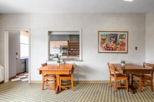 a dining room with two tables and a kitchen at Guest House on the Mount in London