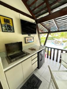 an outdoor kitchen with a stove and a balcony at Nannai Residence Porto Galinhas Praia Muro Alto 101 in Porto De Galinhas
