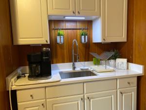 a kitchen with a sink and a coffee maker at The Royal Oak in Cranston