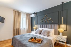 a bedroom with a bed with a tray of oranges on it at Apartments with parking spaces Sutivan, Brac - 20155 in Sutivan
