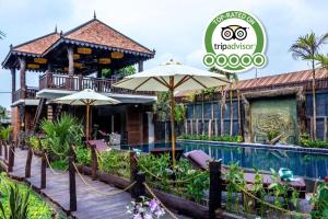 a villa with a swimming pool and a resort at Java Wooden Villa & Residence in Siem Reap