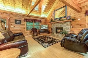 a living room with leather furniture and a fireplace at Return To Me, 3 Bedrooms, Sleeps 9, Pool Table, Hot Tub, Gas Fireplace in Sevierville