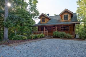 a log home with a driveway in front of it at Return To Me, 3 Bedrooms, Sleeps 9, Pool Table, Hot Tub, Gas Fireplace in Sevierville