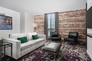a living room with a couch and two chairs at JW Marriott Savannah Plant Riverside District in Savannah