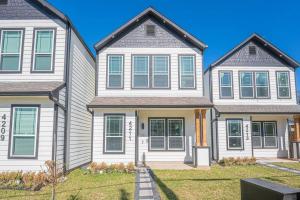 a large house with whiteiding and green shutters at The Right Studio @ East Downtown in Houston