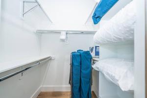 a bedroom with a bunk bed and a blue jumpsuit at The Right Studio @ East Downtown in Houston
