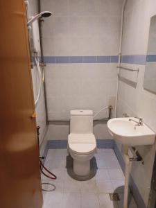 a bathroom with a toilet and a sink at T Hotel Anggerik in Alor Setar