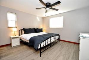 a bedroom with a bed and a ceiling fan at King Bed! Quiet Pittsburgh Home! Close to City! in Pittsburgh