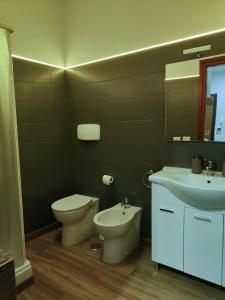 a bathroom with a toilet and a sink at Roma Grey Suite in Rome