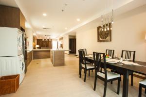 a kitchen and dining room with a table and chairs at Garden Sentral Hotel in Kuala Belait