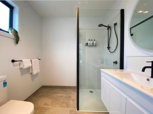 a bathroom with a shower and a sink at Albatross Rise - Modern Family Home in Hobart