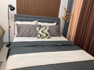 a bed with two pillows on it in a bedroom at Alleia's Place at Tagaytay in Tagaytay +30 photos
