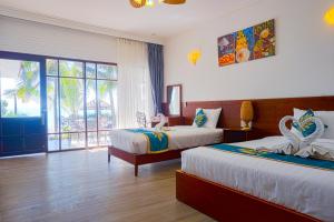 Postel nebo postele na pokoji v ubytování Ravenala Muine Resort