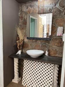 a bathroom with a sink and a mirror at Carod Espacio Serrano in Salsipuedes