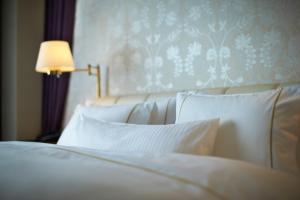 a bedroom with two white beds and a lamp at The Westin Osaka in Osaka