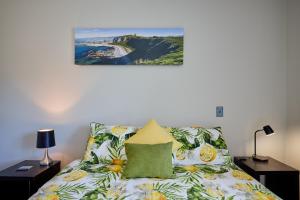 a bedroom with a bed and a painting on the wall at Golfer's Retreat in Kaikoura