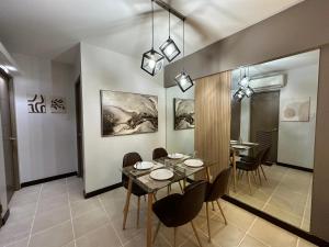 a dining room with a table and chairs at Alea Residences in Manila