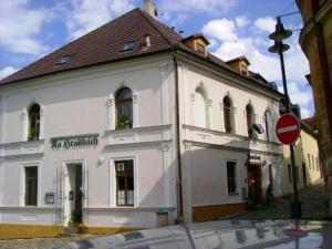 a white building on the corner of a street at Pension Na Hradbach in Tábor