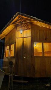 a small wooden cabin with windows on the side of it at Tipis Ya' in San Pedro La Laguna