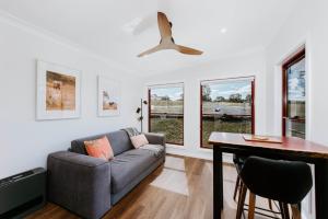 a living room with a couch and a table at Hepburn Retreat at Valley View, Ilford NSW in Ilford