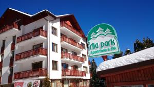 a building with a sign in front of it at TES Rila Park Apartments in Borovets +21 photos