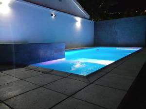 a swimming pool at night with blue water at Doña Vanina in Villa Larca