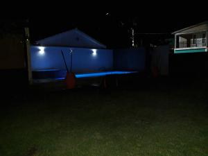a ping pong table in a backyard at night at Doña Vanina in Villa Larca