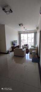 a large living room with couches and a large window at Asian Residencies @ Trillium, Colombo 7 in Colombo