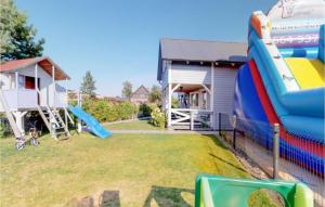 a backyard with a inflatable slide and a house at 2 Bedroom Pet Friendly Home In Karwia in Karwia