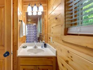 a bathroom with a sink and a mirror at Macys Hideaway in Sevierville +29 photos