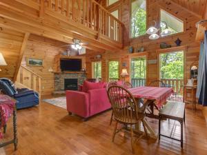 a living room with a table and a fireplace at Macys Hideaway in Sevierville