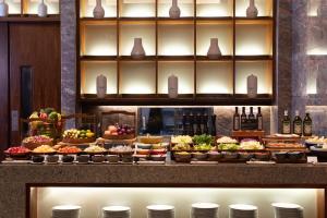 a buffet line with many different types of food at Fairmont Sanya Haitang Bay in Sanya