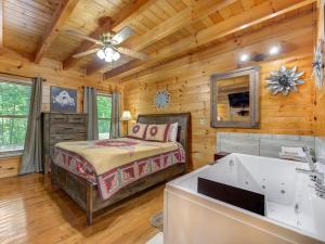 a bedroom with a bed and a ceiling fan at Macys Hideaway, 1 Bedroom, Hot Tub, WiFi, Sleeps 7 in Sevierville