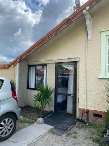 a front door of a house with a car parked outside at Young Hostel in Rotorua