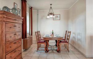 ein Esszimmer mit einem Holztisch und Stühlen in der Unterkunft 2 Bedroom Gorgeous Home In Ijzendijke in IJzendijke