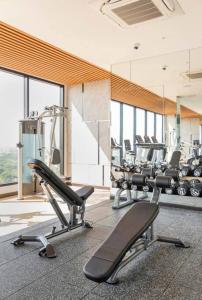 a gym with a row of treadmills and machines at Astra Sky River Pool By Duke 07 in Chiang Mai