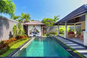 a swimming pool in the backyard of a villa at Agata Villas Seminyak in Seminyak